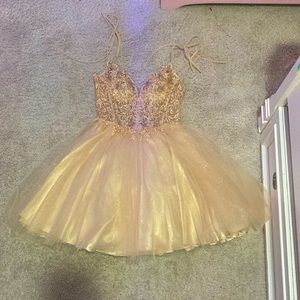 a gold dress in the brand of Ladivine in the size xs